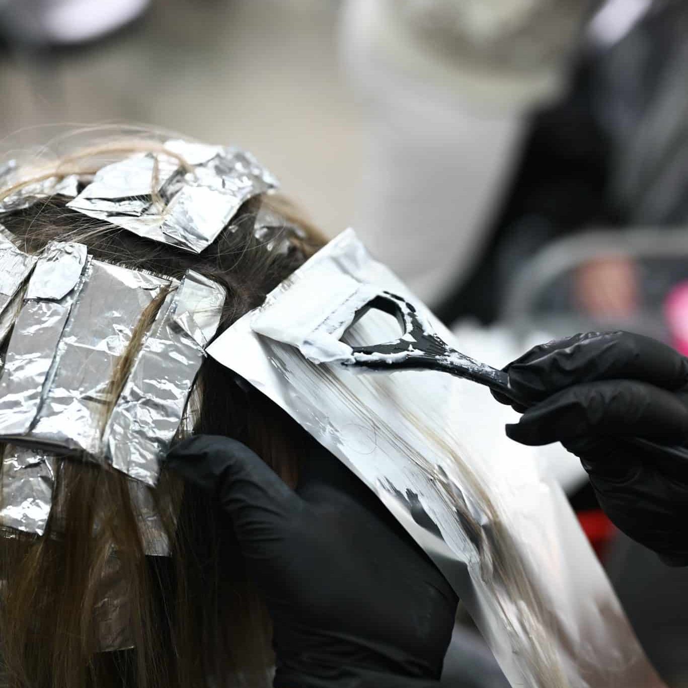 hair being bleached at a salon We provide high quality and professional toner for blonde hair at Caprio's Hair Studio